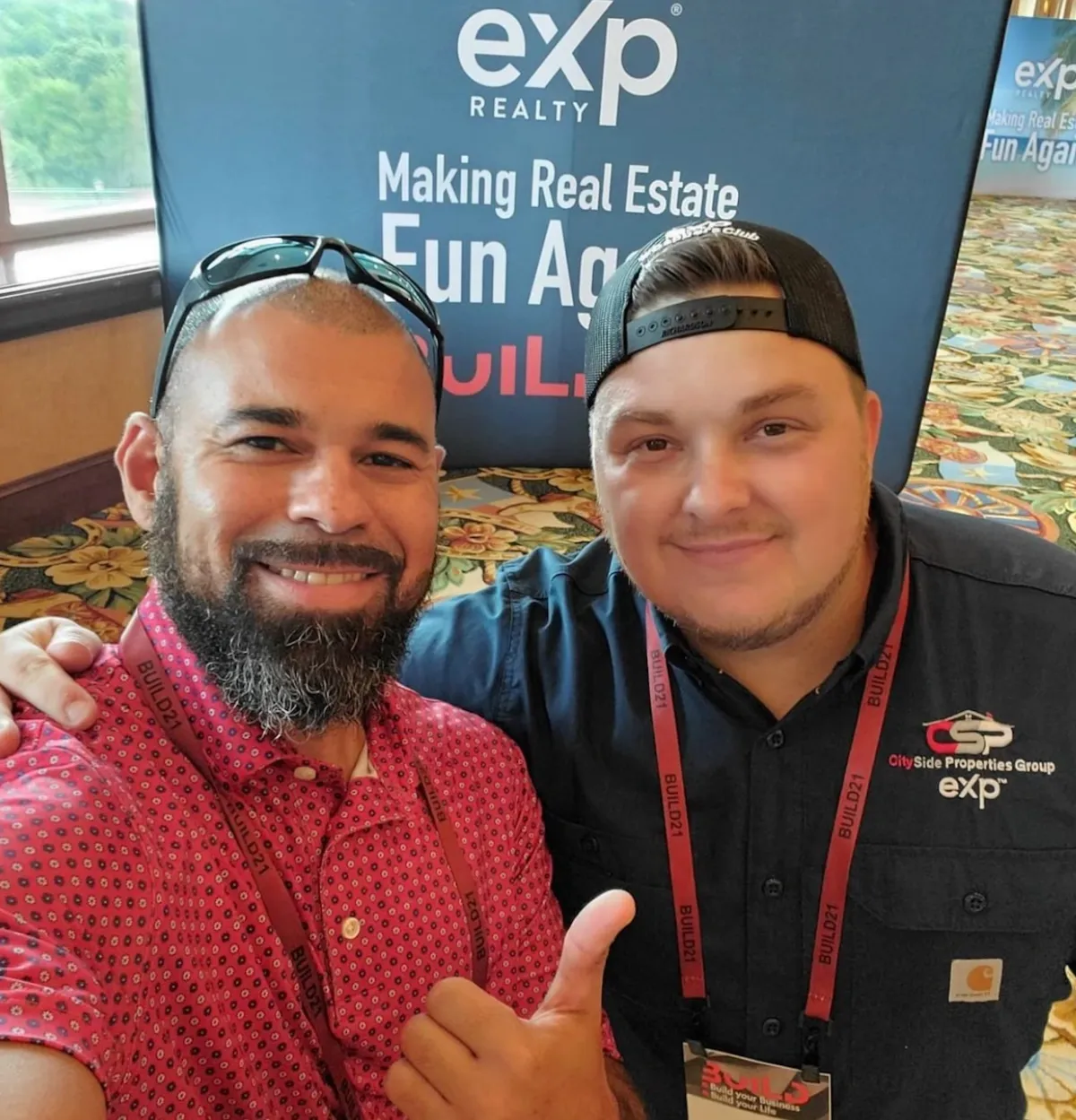 Two Team Legacy agents at an eXp Realty event